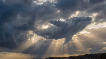 Prompt on Nano Banana Pro : A dramatic sky photo where swirling storm clouds naturally form the unmi