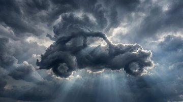 Prompt on Nano Banana Pro : A dramatic sky photo where swirling storm clouds naturally form the unmi